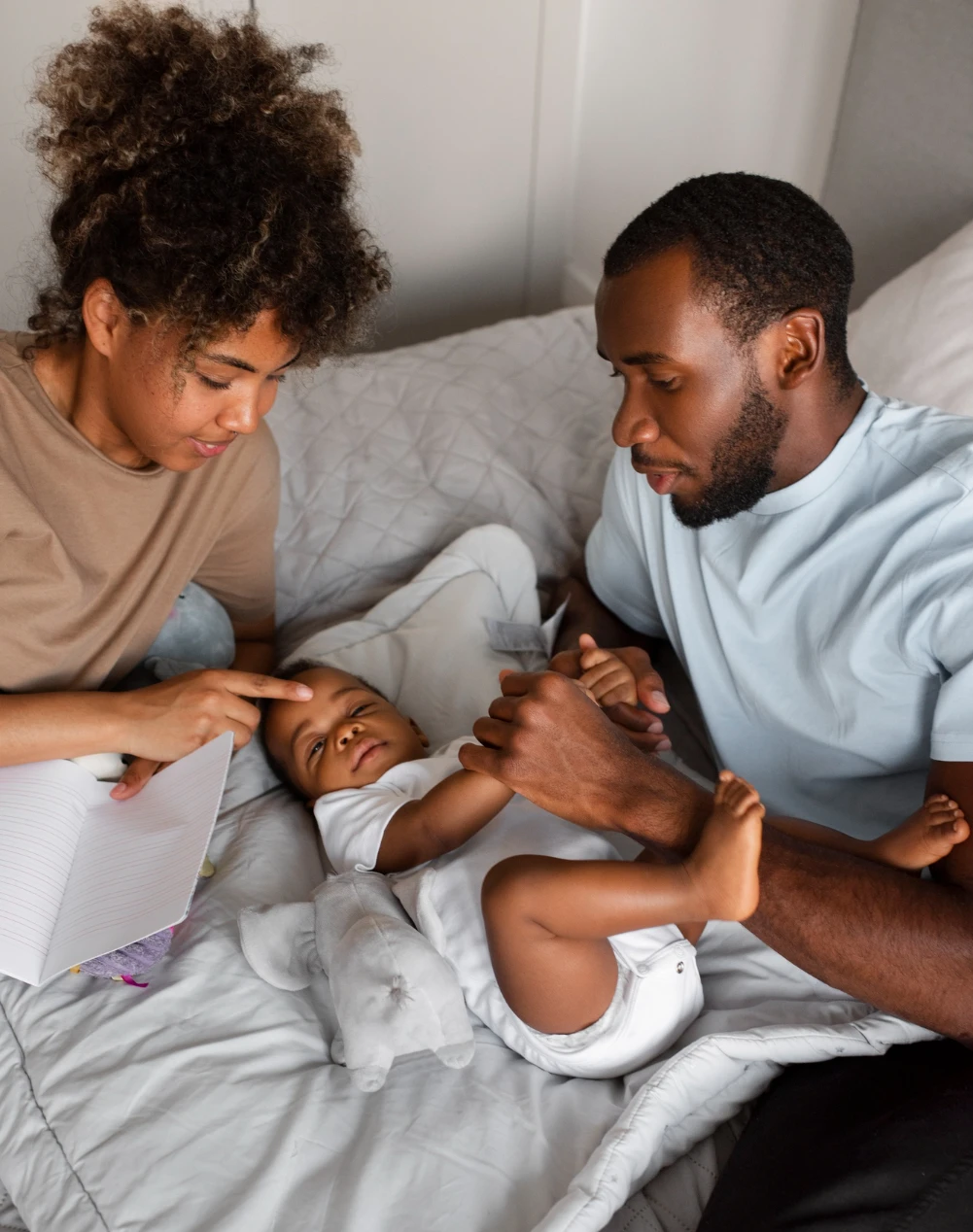 A parent holding a sleeping newborn